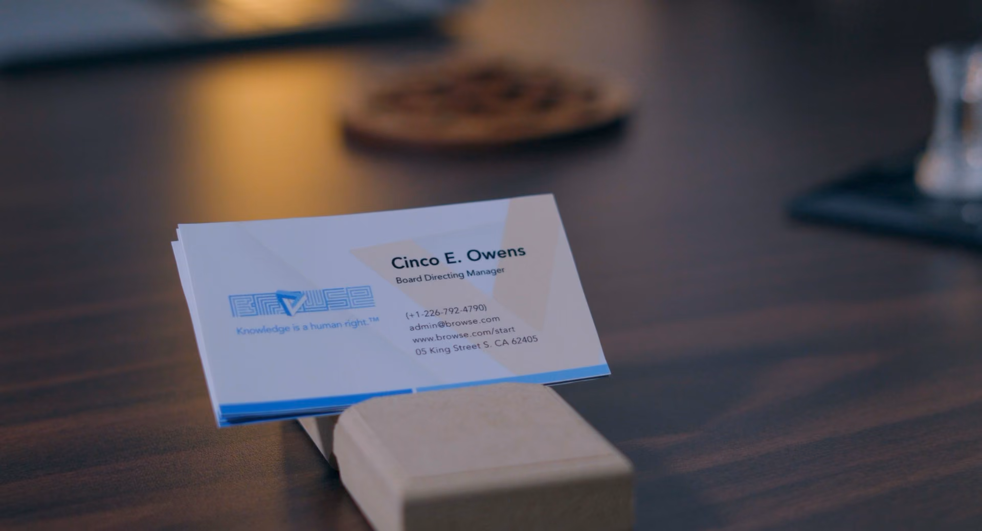 Business card on a desk with the printed name Cinco E. Owens.