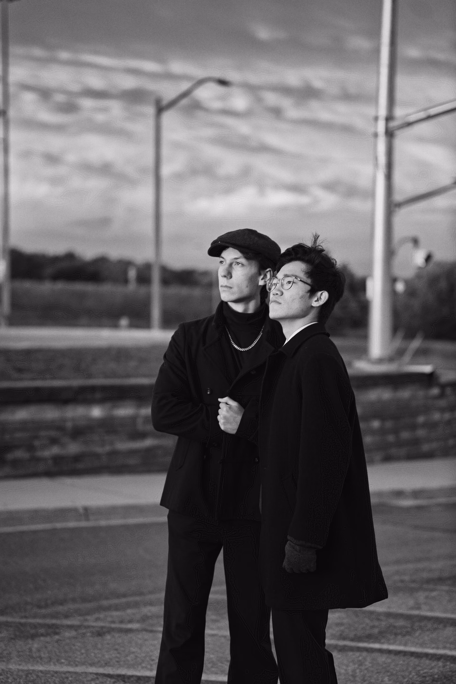 Two filmmakers stand together outdoors in a monochrome photograph.