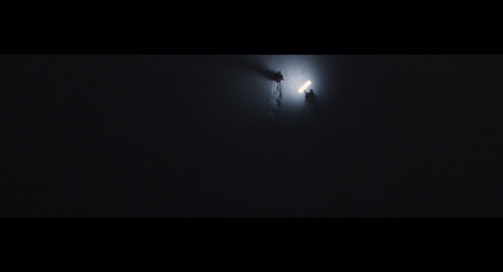 Figures beside a light at night in Wattleseed